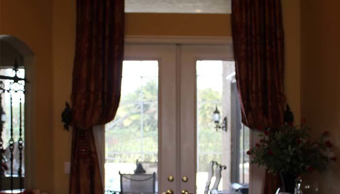 Sliding Door with Curtains — Okeechobee FL — Custom Window Treatments & Blinds
