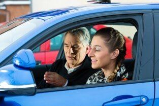 Young woman taking instructions from her driving instructor — Road Lessons in Bloomfield, NJ