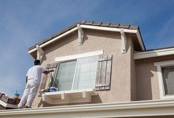 Man painting shutters — Exterior Painting in Salem, OR