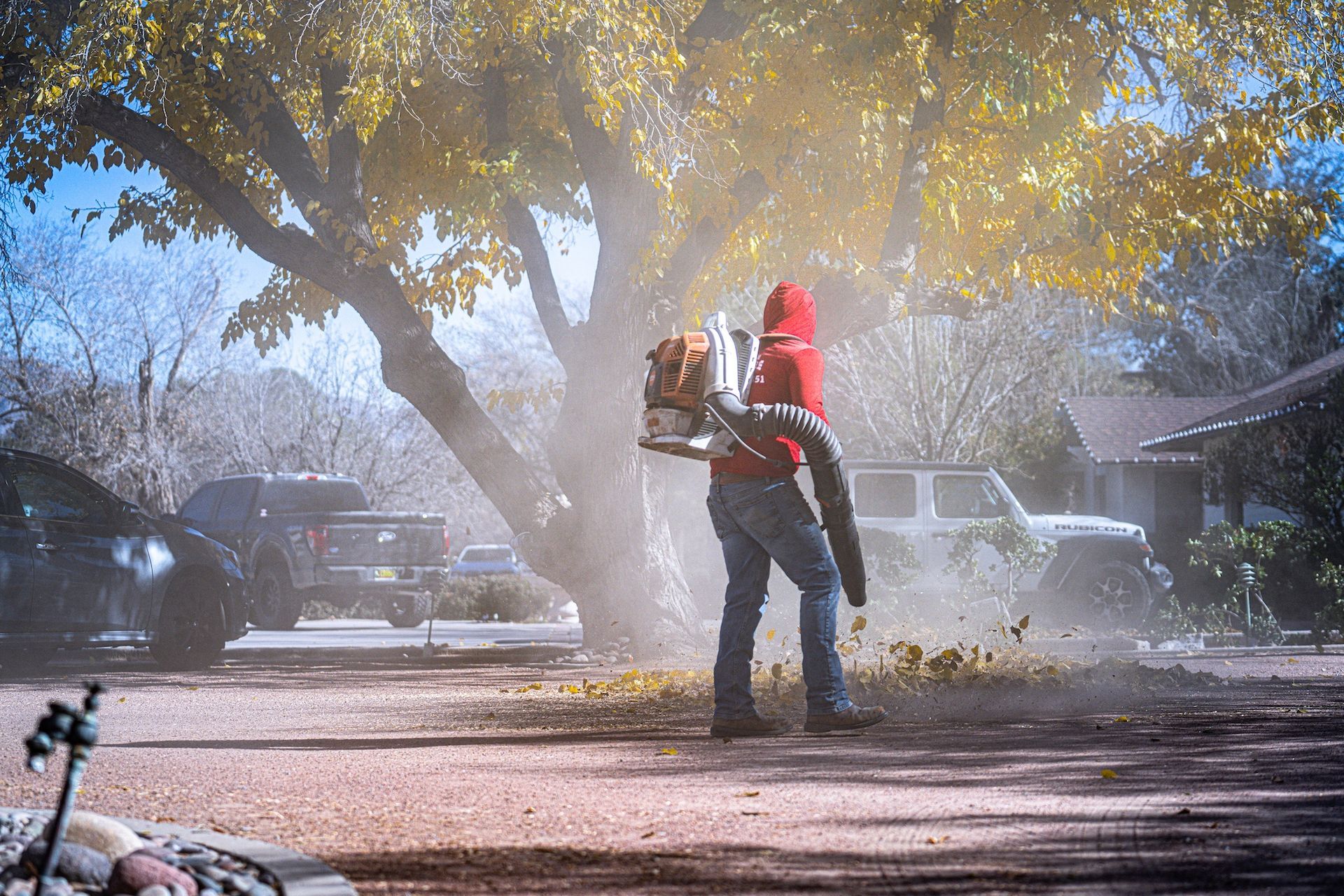 A red truck with a trailer attached to it is parked in a parking lot.
