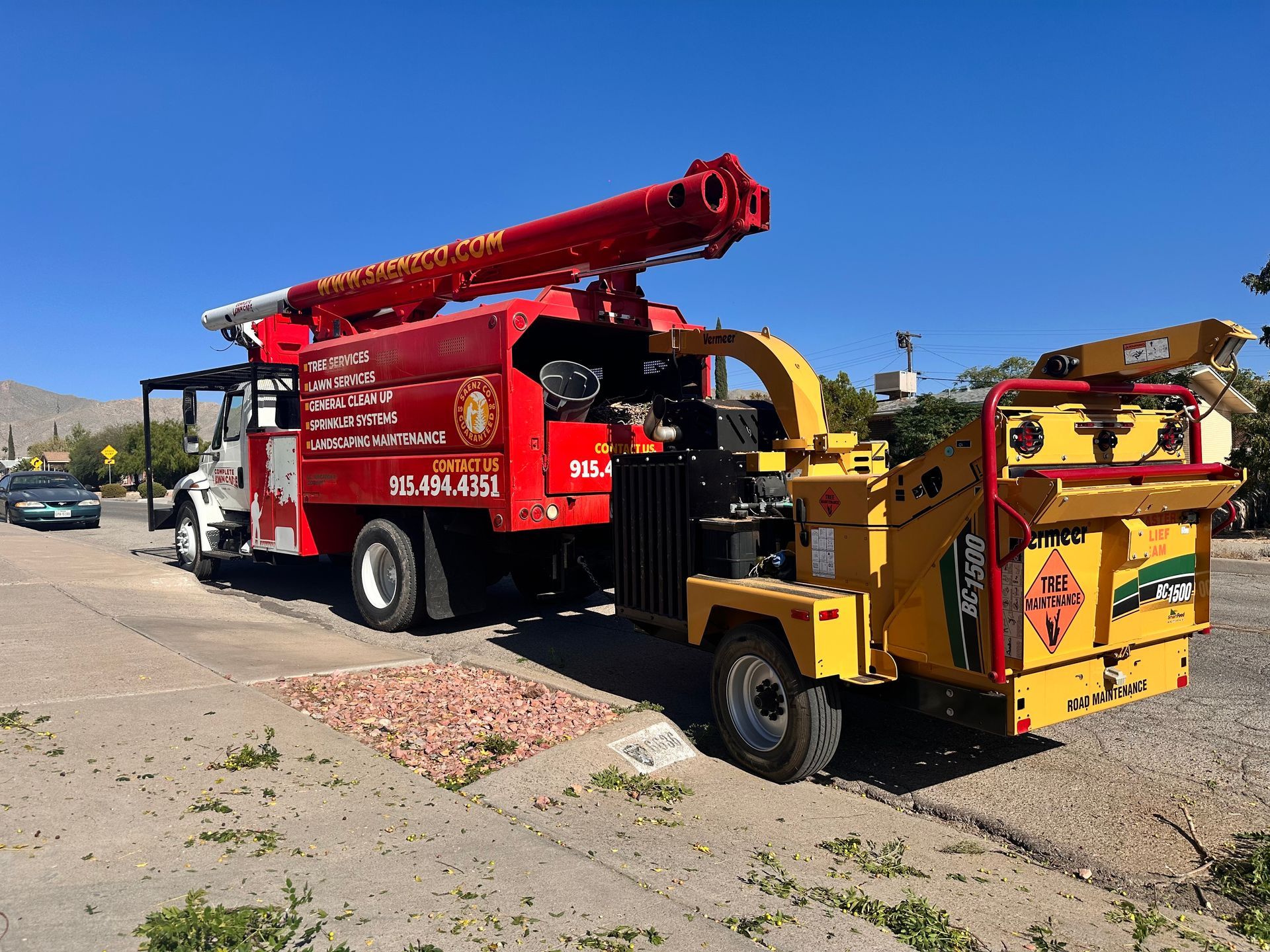 A red and yellow truck is parked on the side of the road.