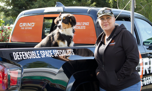 Lori Templeton and Dog in a grind fire defense truck