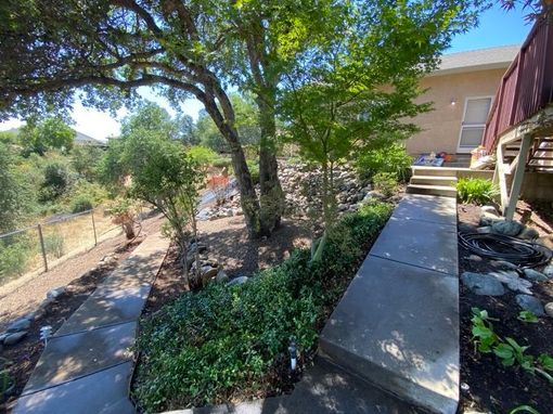 men working on defensible space for egress roads