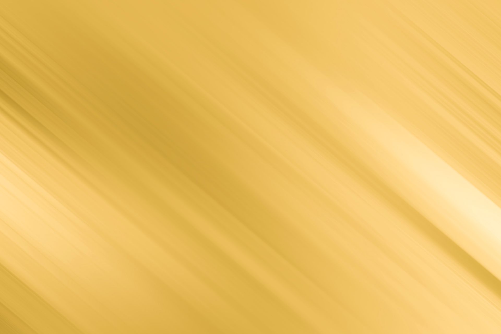 A close up of a gold background with a diagonal striped pattern.