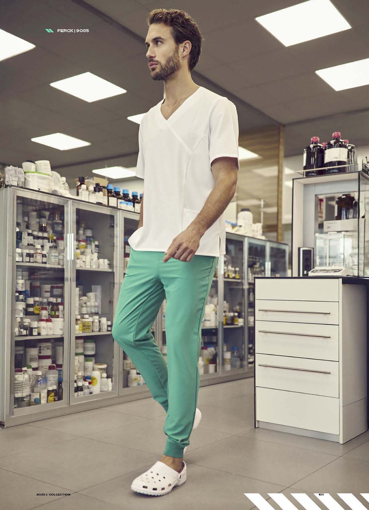 Ένας άντρας με λευκό πουκάμισο και πράσινο παντελόνι στέκεται σε ένα φαρμακείο.