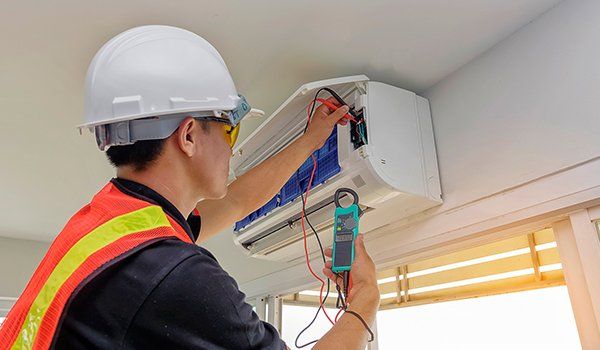 A technician doing HVAC maintenance in Lusby, MD