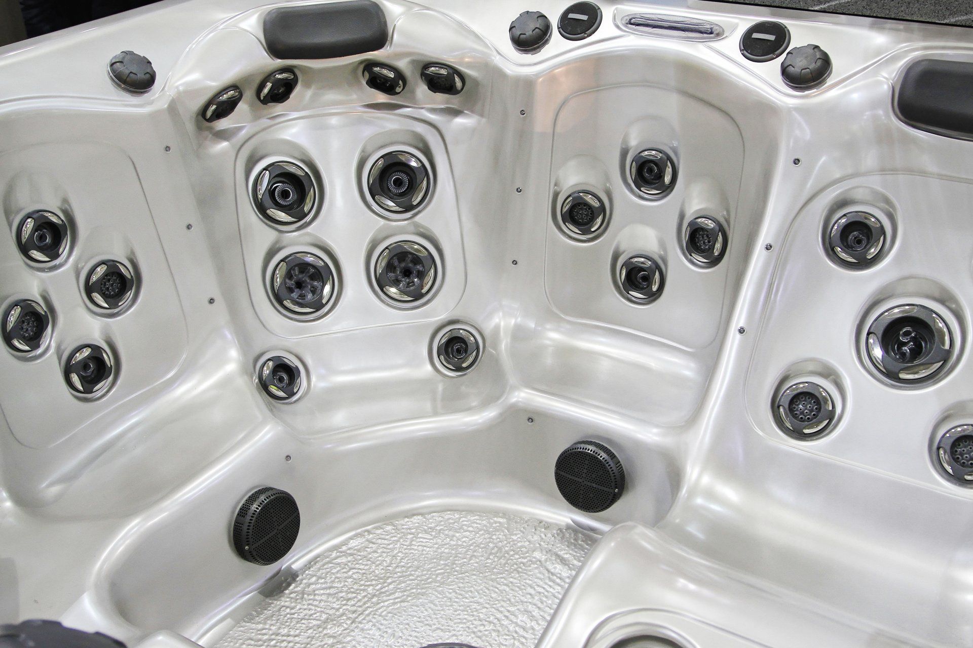 The inside of a hot tub with a lot of jets.