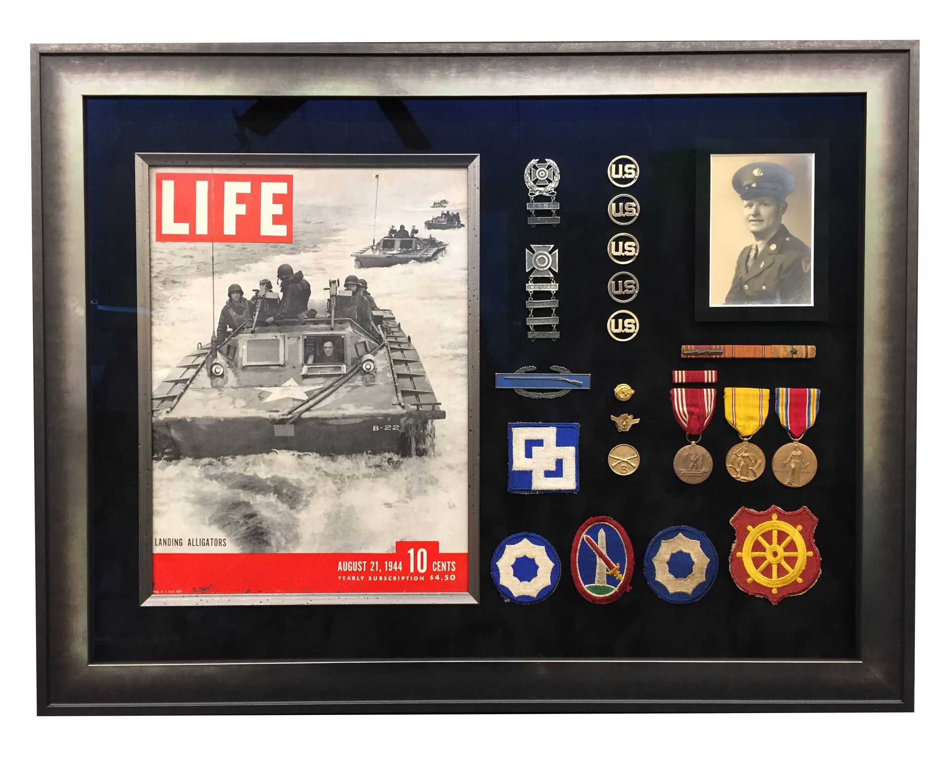 Shadow box with a LIFE magazine cover, medals, and a portrait.