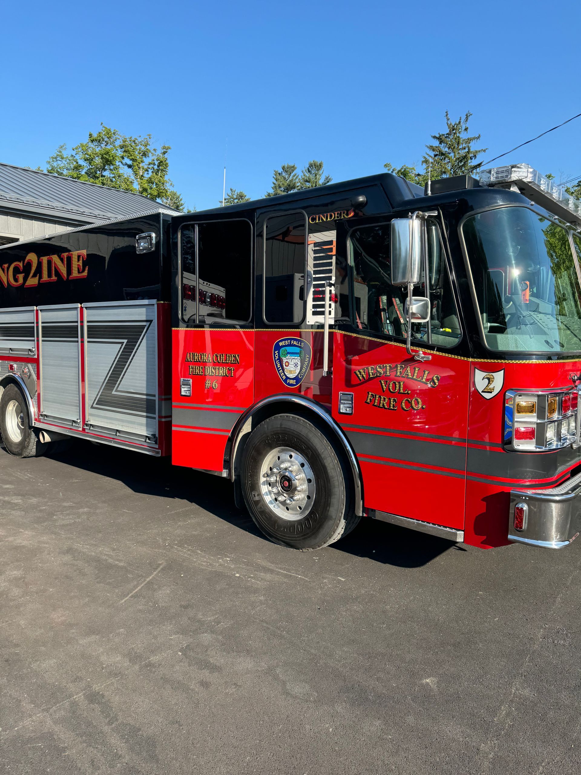 A red fire truck is parked on the side of the road.
