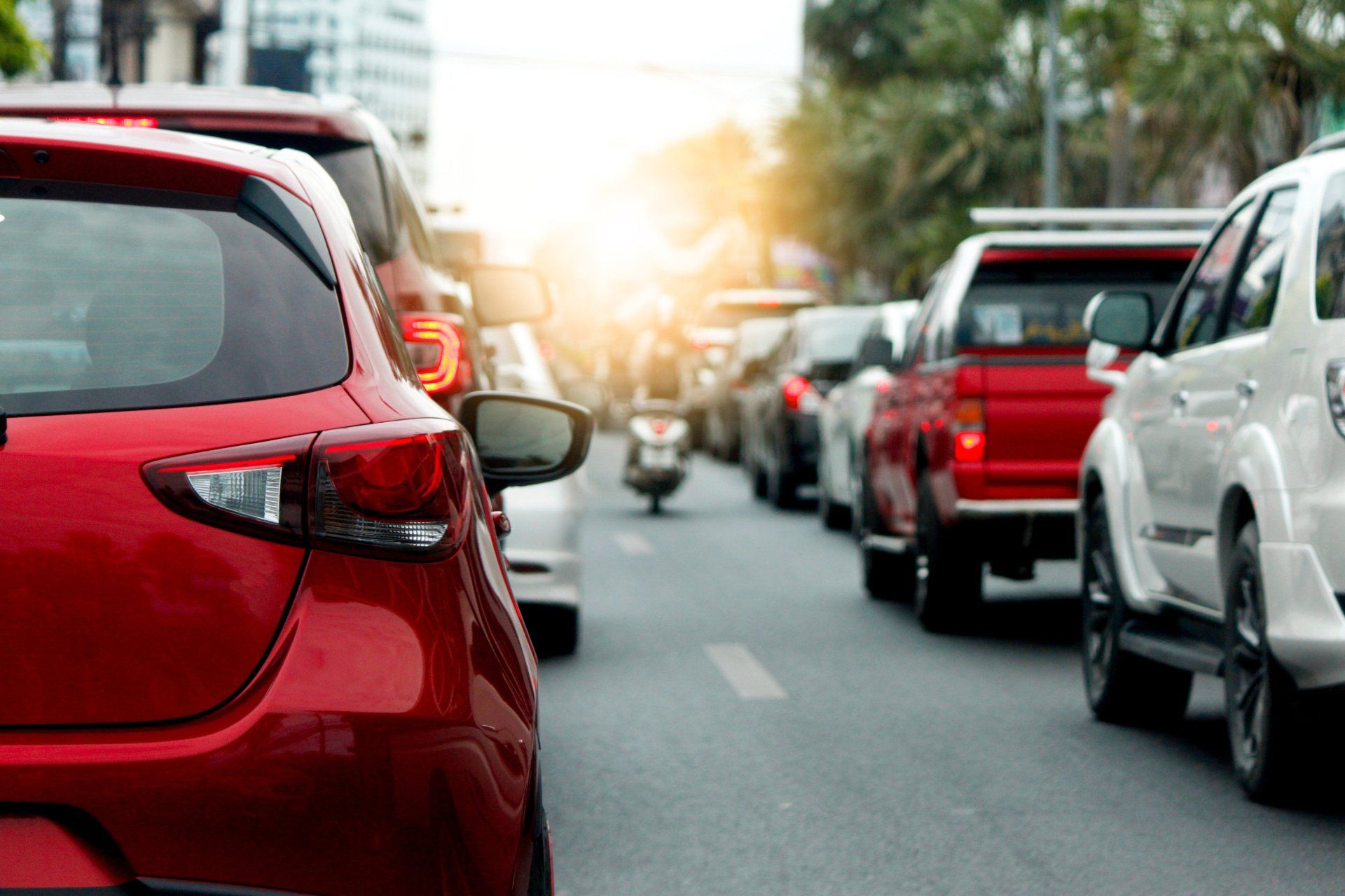 motorcycle between cars in traffic