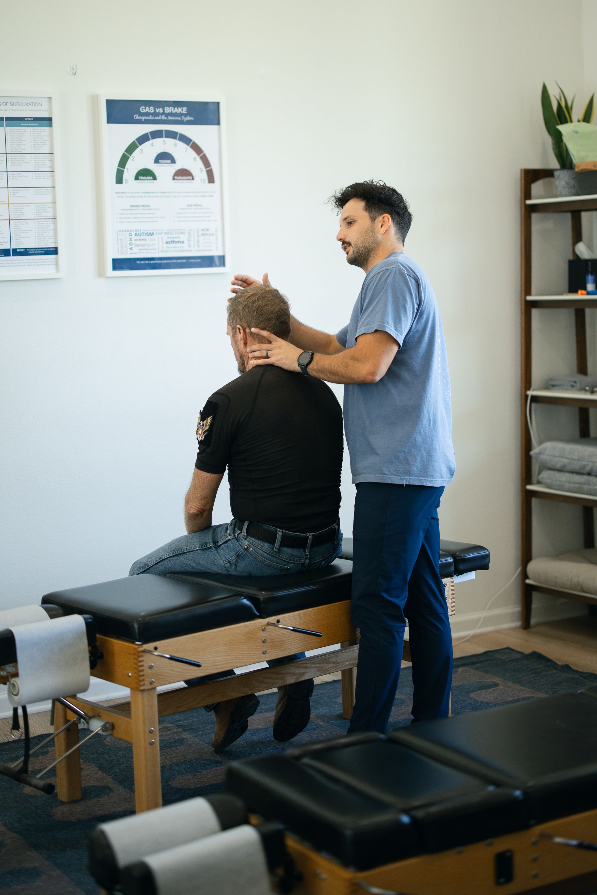 Exhausted parent recieving an adjustment to help his nervous system thrive