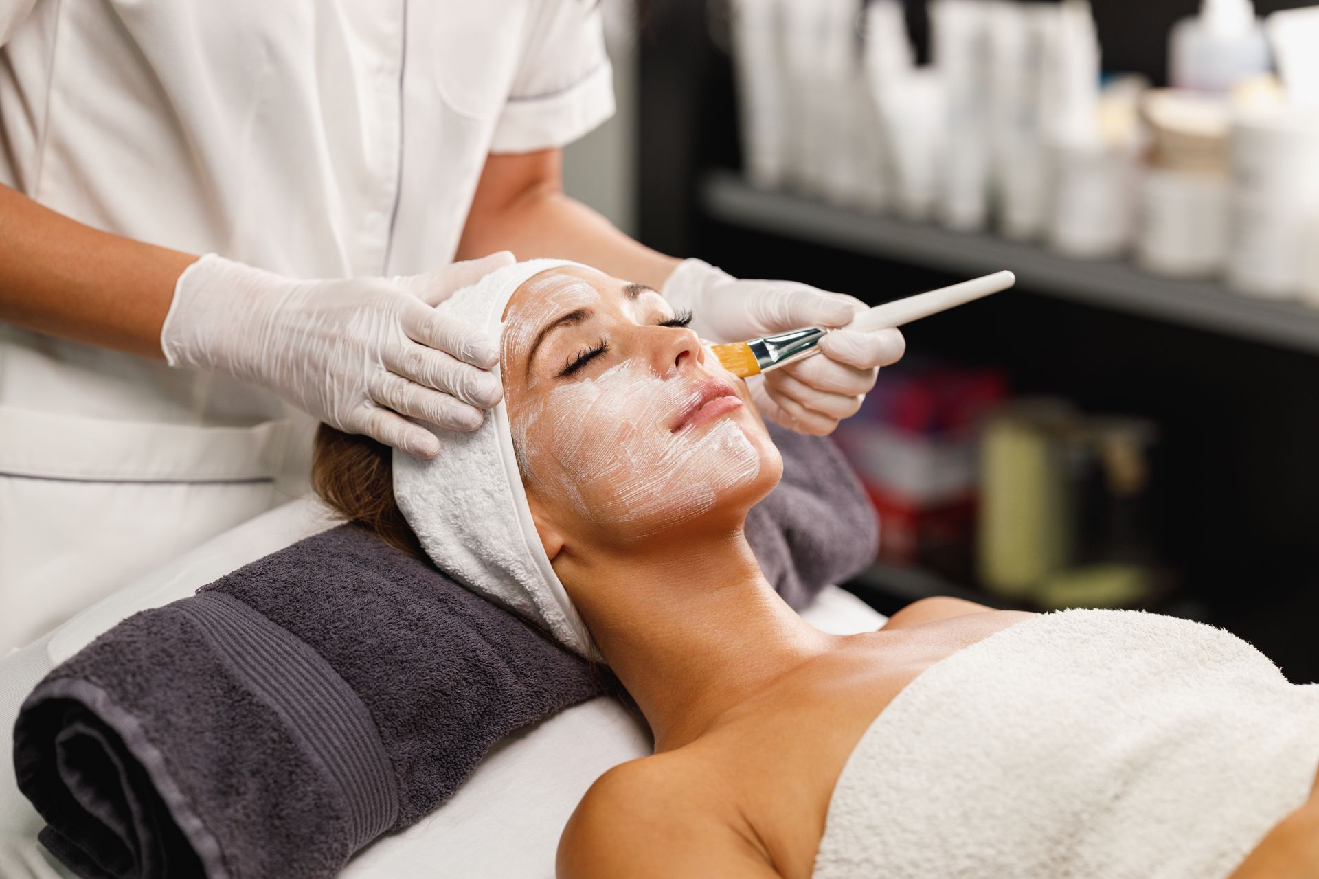 a woman getting a facial with a brush