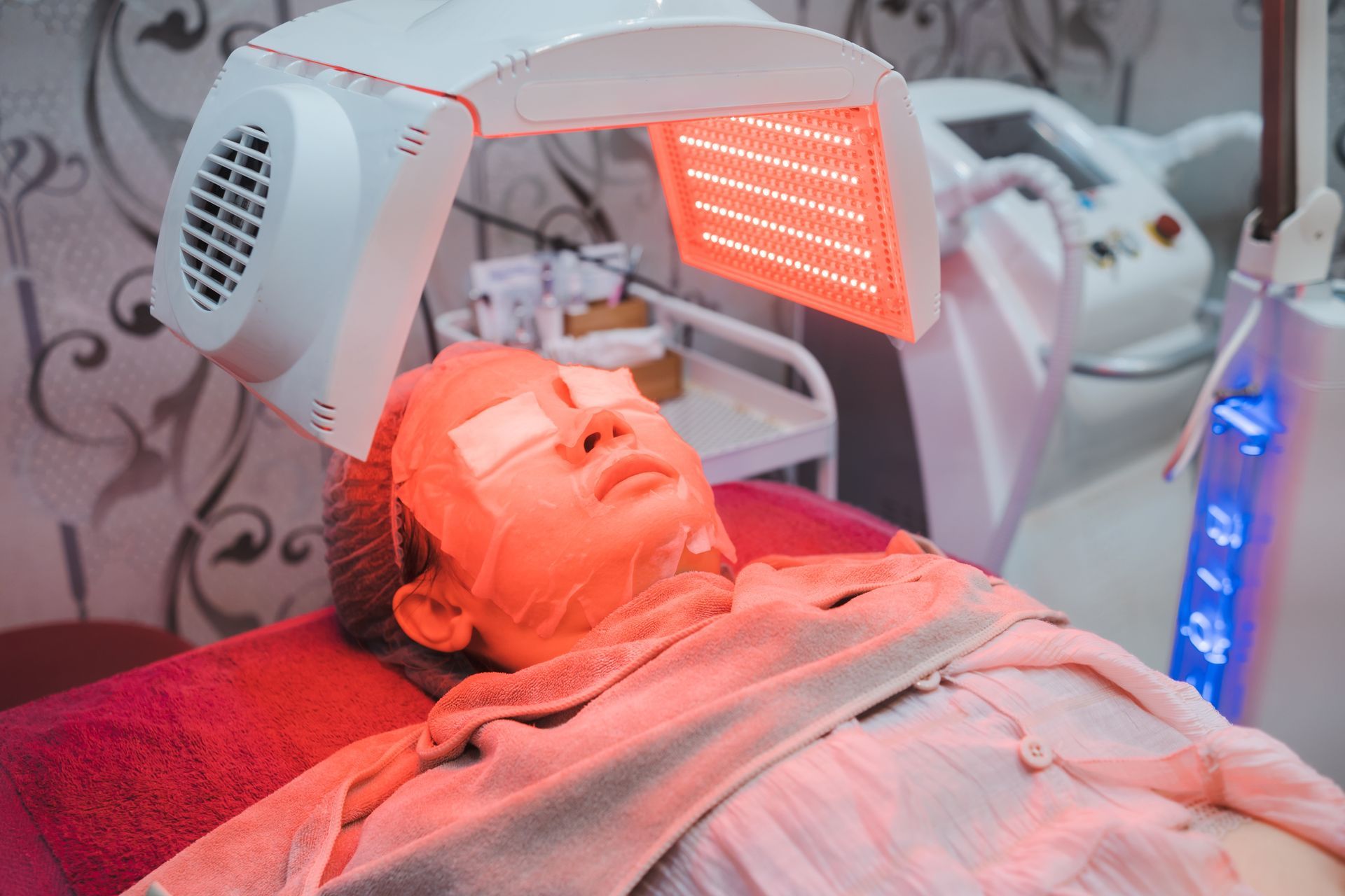 a woman getting led therapy on her face