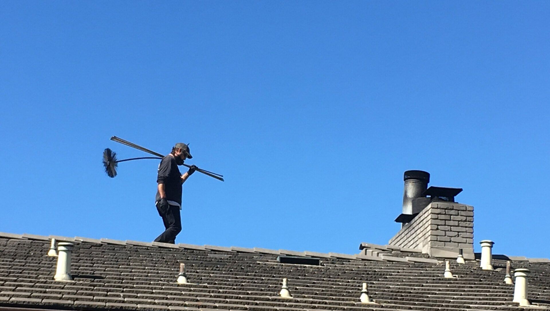 Chimney sweeper on roof — Monterey Bay, CA — Keystone Chimney Sweeps