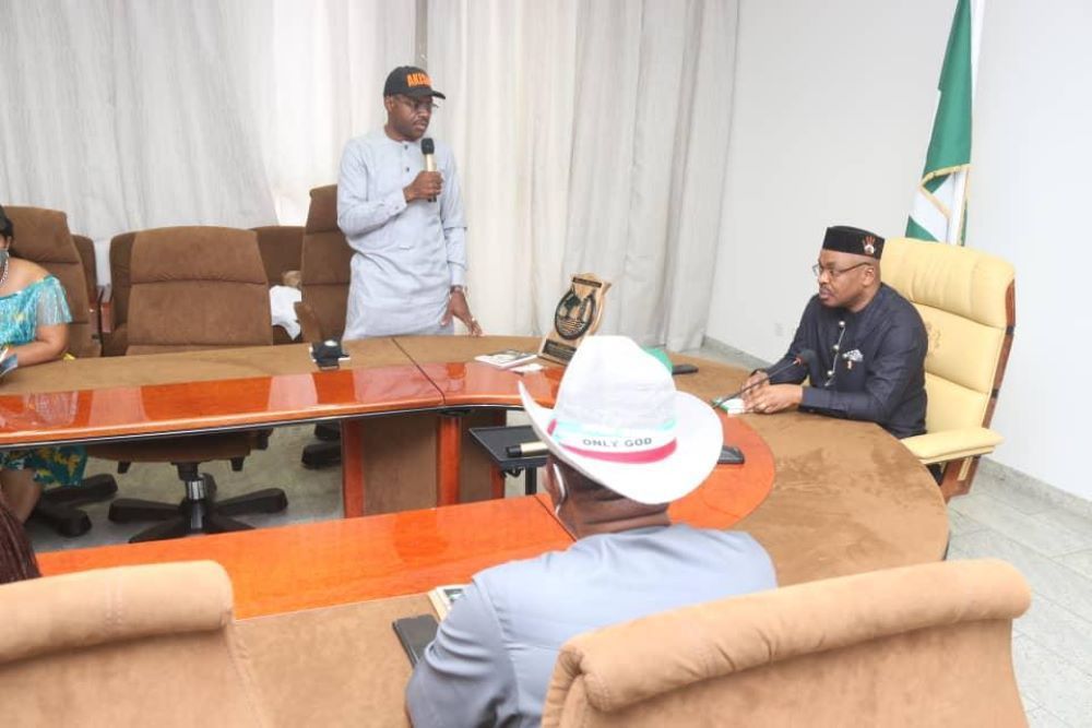 A man in a cowboy hat is sitting at a table with other people.