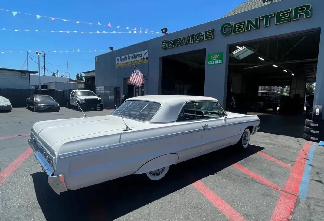 White car parked in front of garage in San Leandro, CA | Angel's Auto Repair And Service
