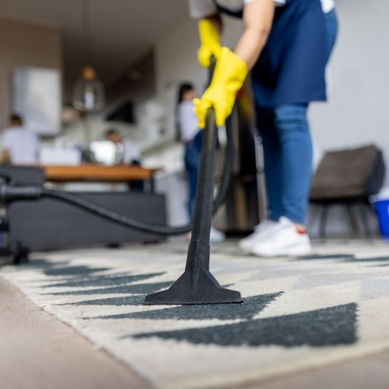 A Person Wearing Yellow Gloves Is Using a Vacuum Cleaner to Clean a Rug | Hagerstown, MD | King's Fabulous