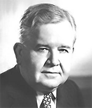 A black and white photo of a man in a suit and tie.