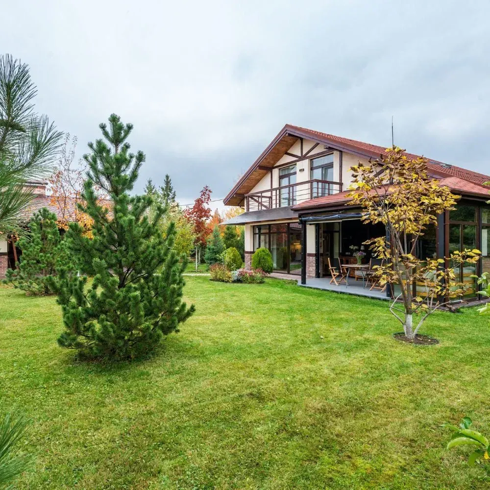 A large house with a large lawn in front of it.