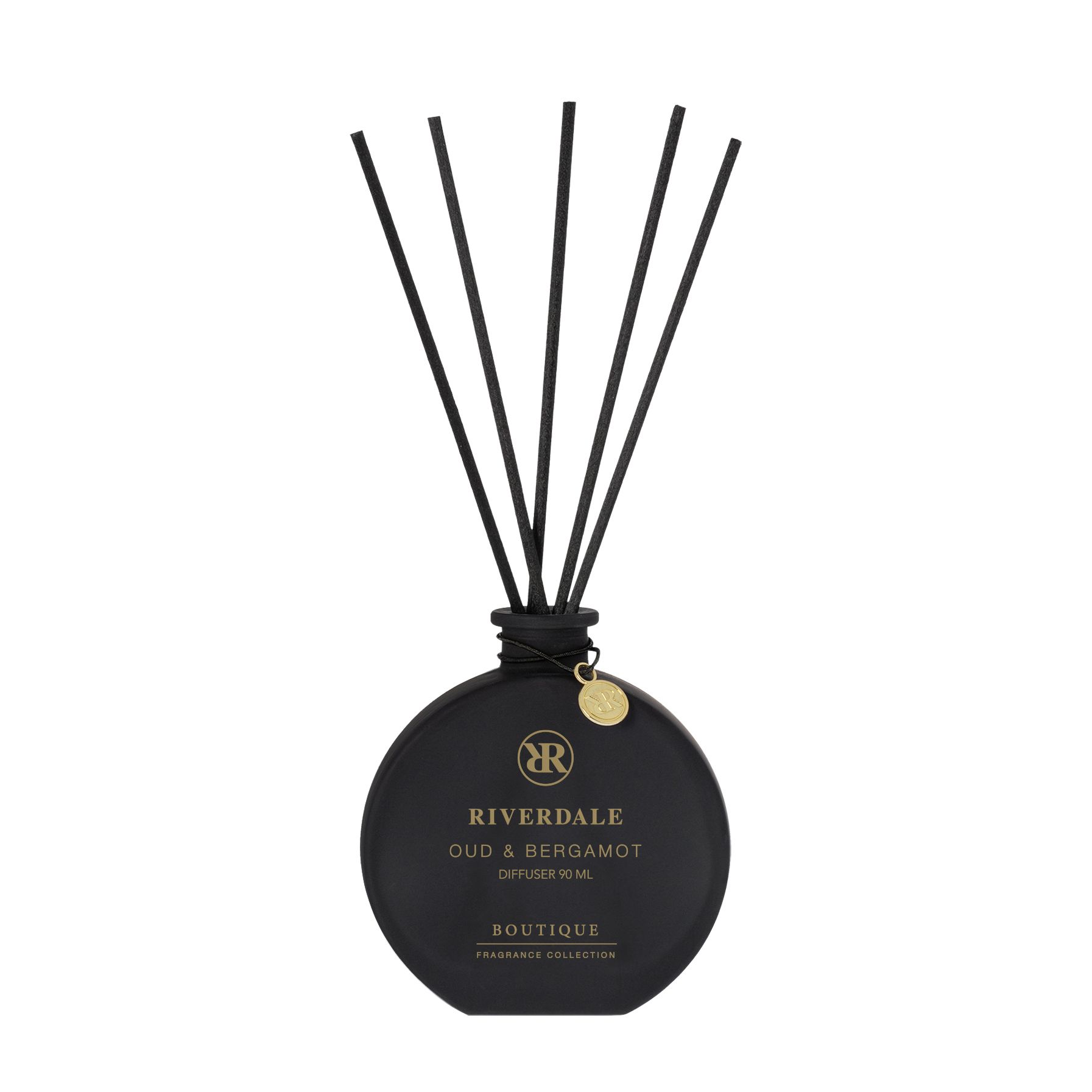 Roze Riverdale diffuserdoos naast een zwarte rietdiffuserfles met lange zwarte stokjes.