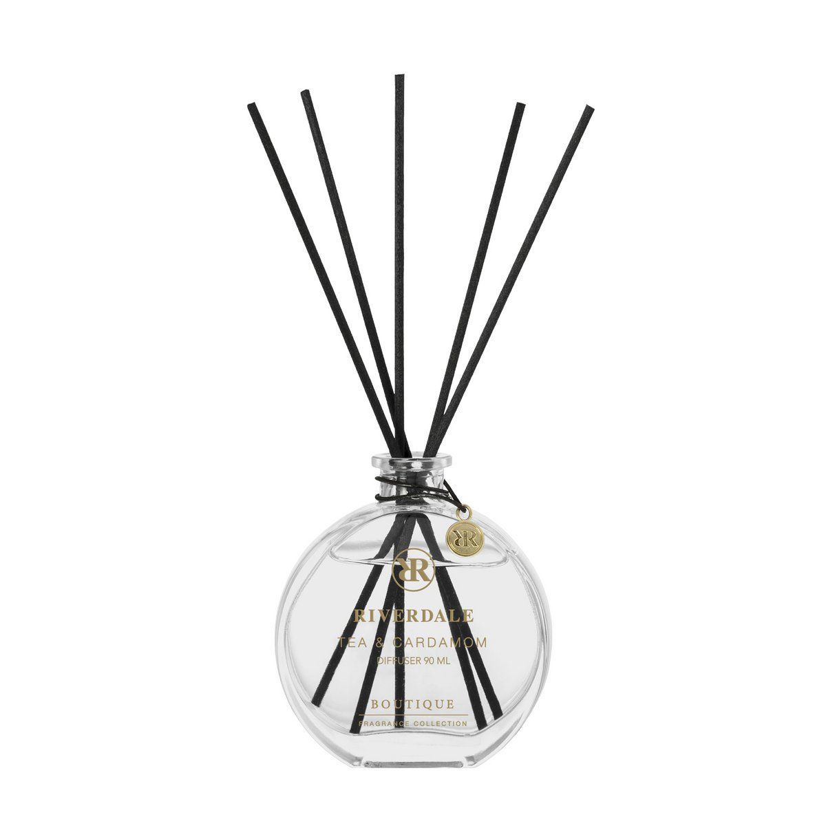 Donkergroene geschenkverpakking met rietdiffuser naast een doorzichtige glazen fles met zwarte rietjes.