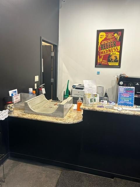 A counter in a store with a poster on the wall above it.