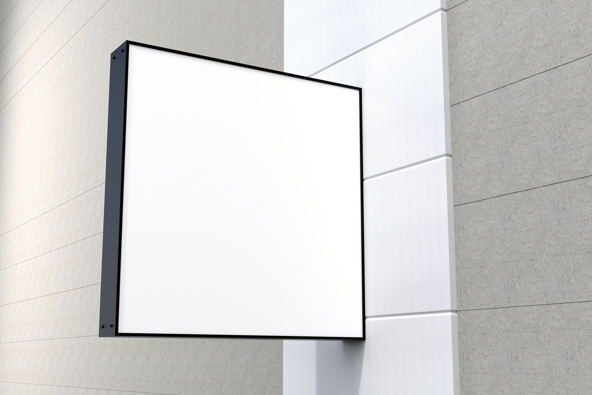 A blank square wall sign with a black frame mounted on a modern concrete building exterior