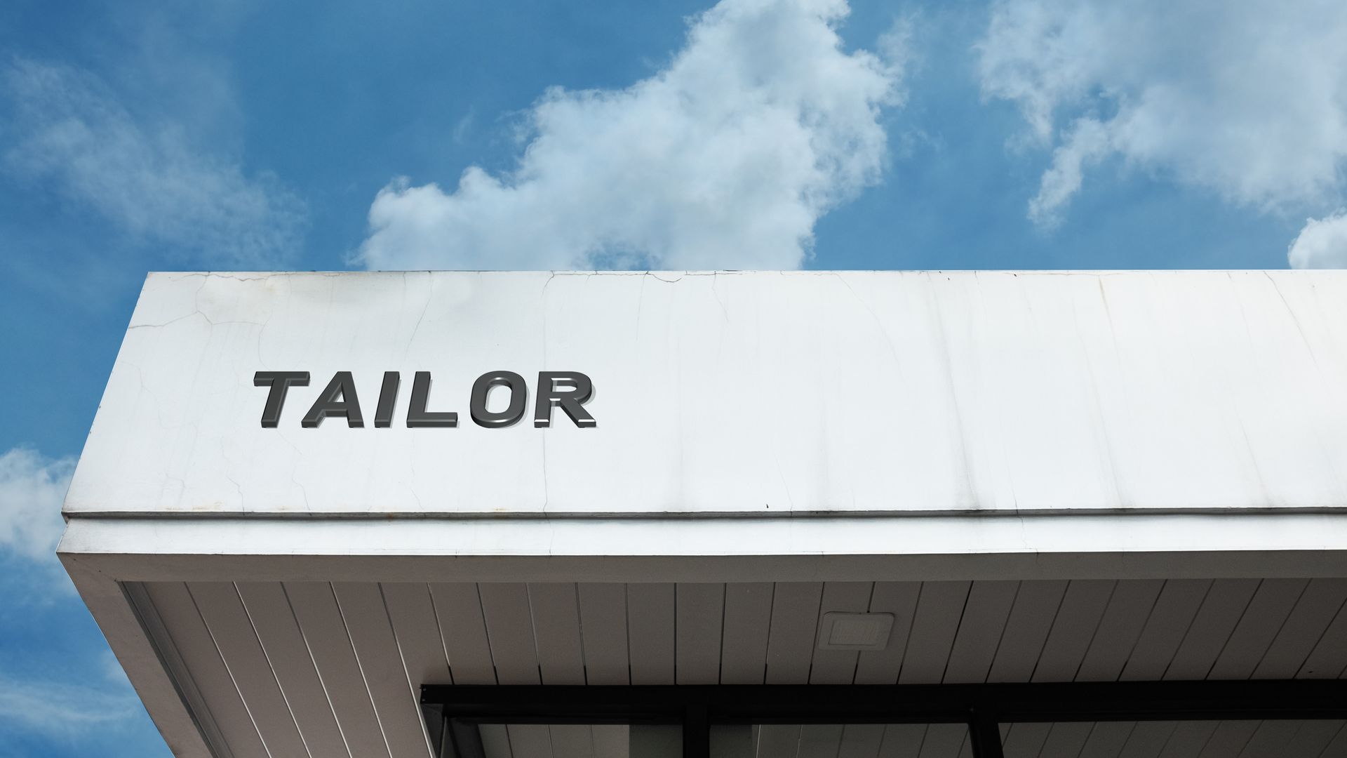 Tailor word signage on a commercial retail building.