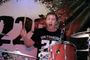 A man in a san francisco shirt is playing drums