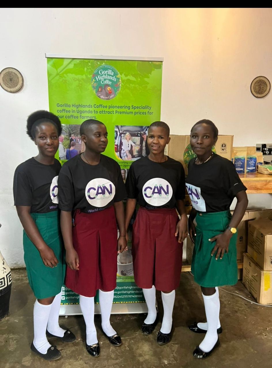 A group of girls standing in front of a sign that says can