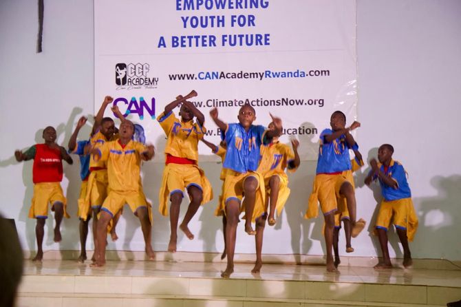 A man is jumping over a fountain in front of a large building