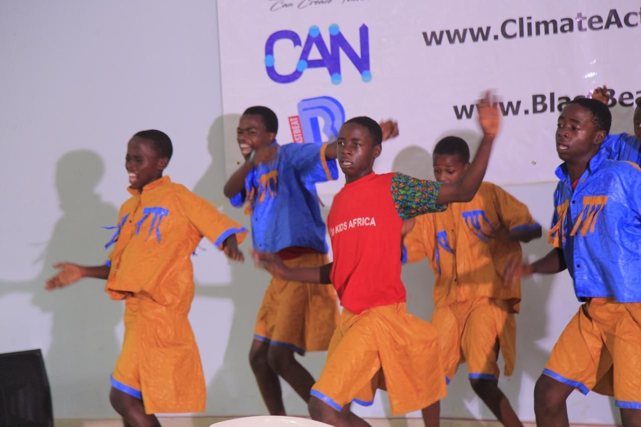 A group of people are standing next to each other in a room.