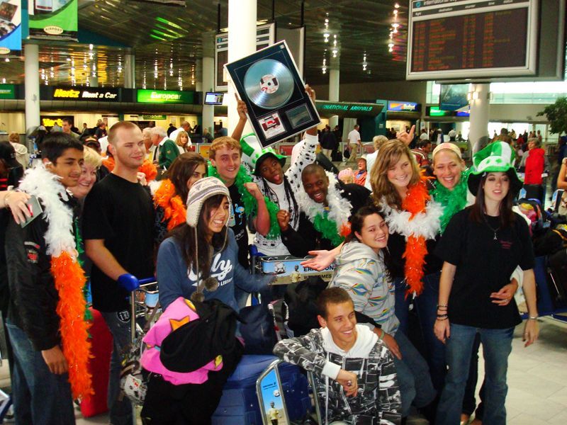 A group of people posing for a picture at an airport