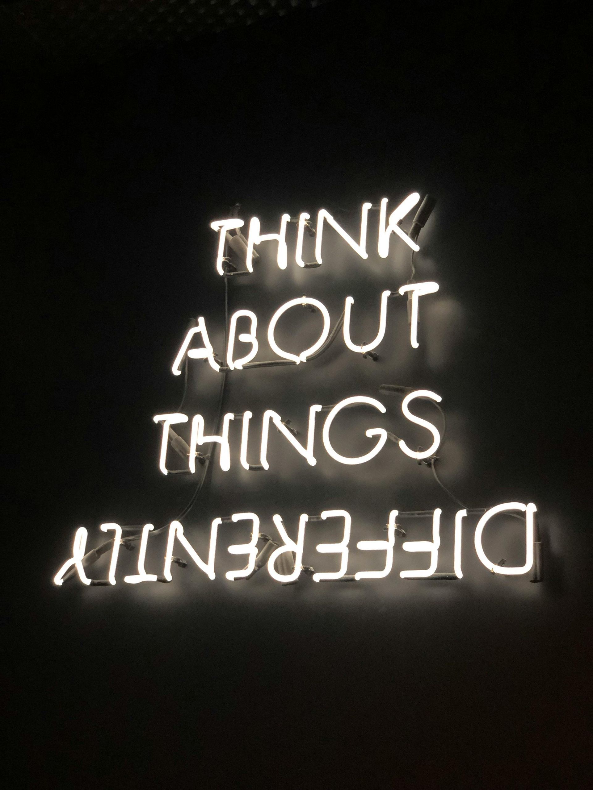 A neon sign that says think about things differently