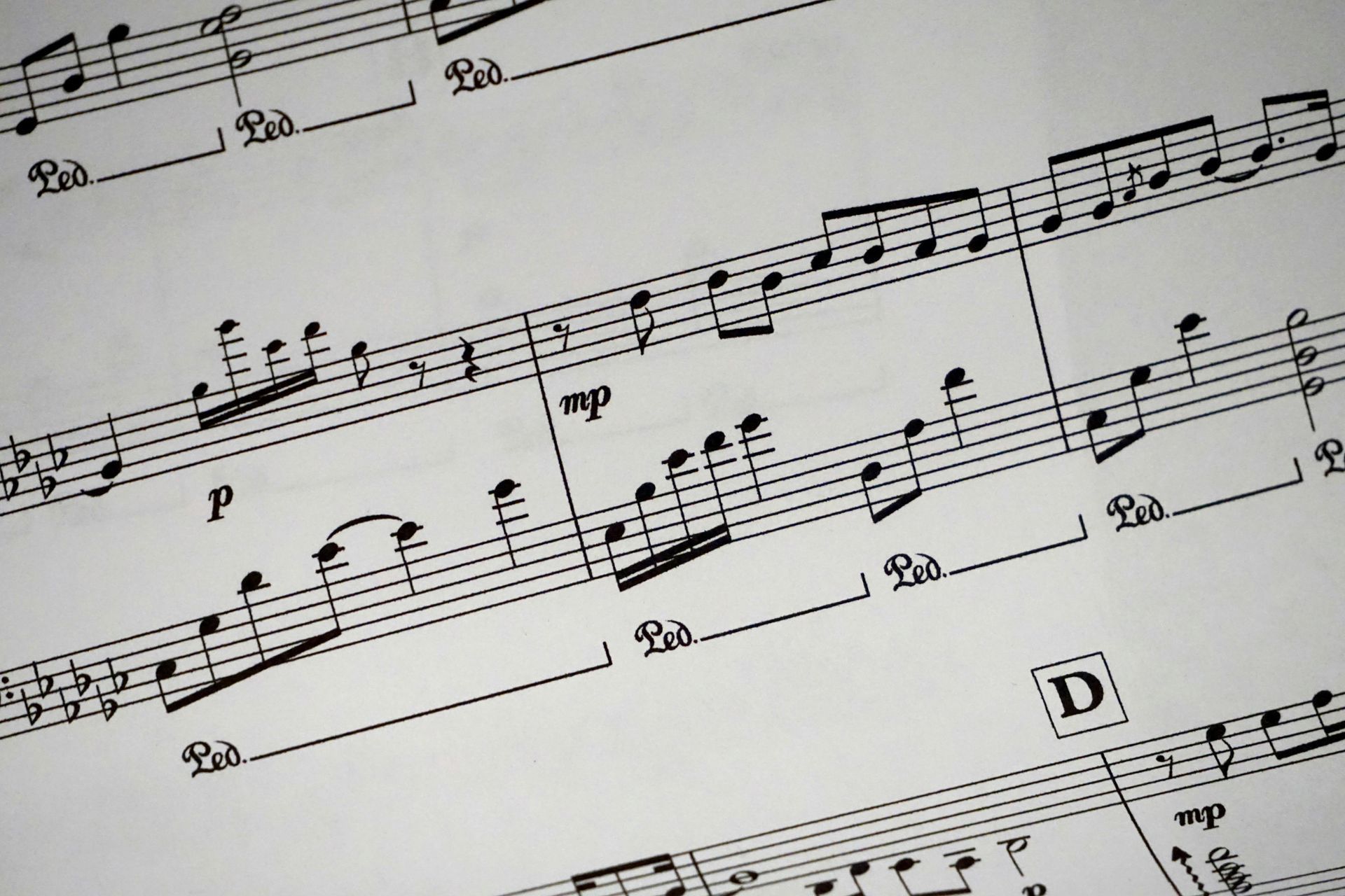 A sheet of music with the letter d in the middle