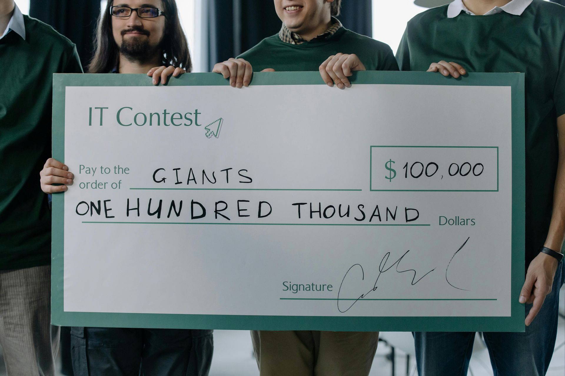 A group of men are holding a large check for one hundred thousand dollars.
