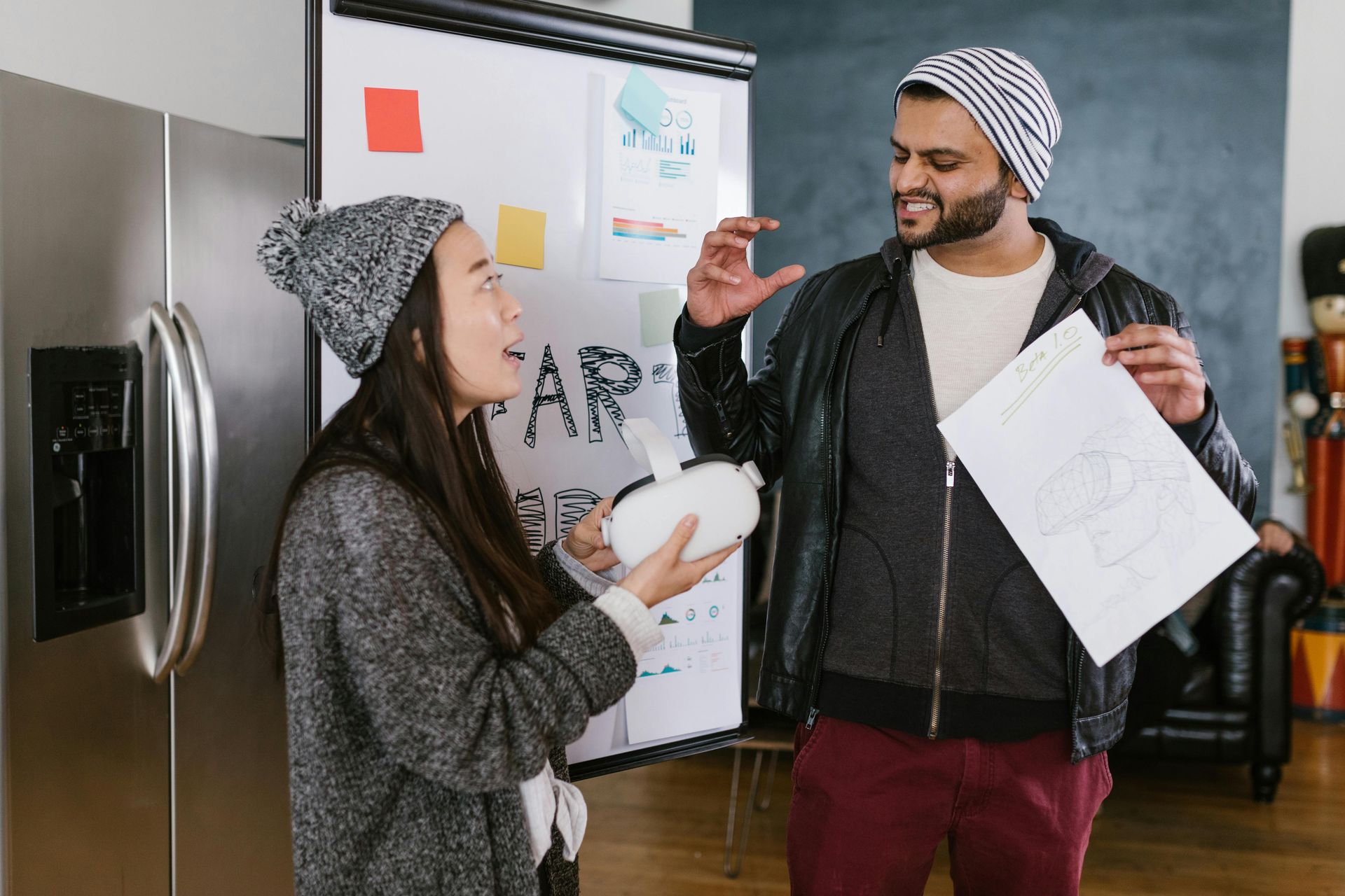 A man and a woman are standing next to each other in front of a whiteboard.