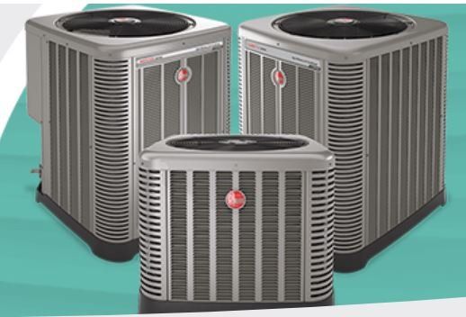 Three air conditioners are sitting next to each other on a green surface.