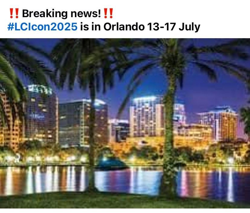 A picture of a city skyline at night with palm trees in the foreground.