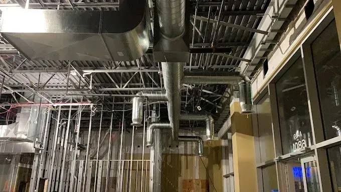 HVAC ductwork and metal framing installed inside a building under construction.
