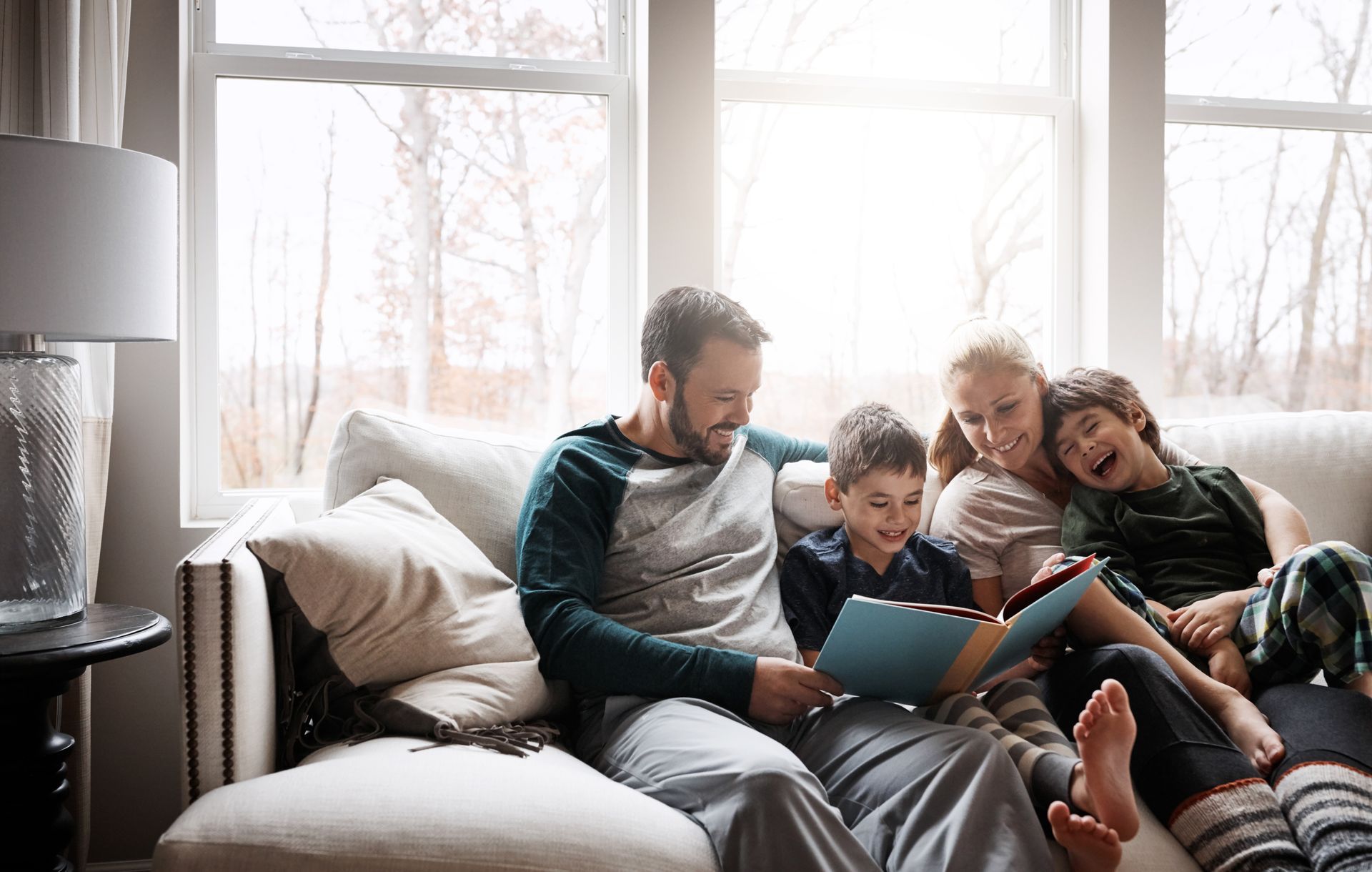 Woman at desk gestures toward man standing, in office setting.