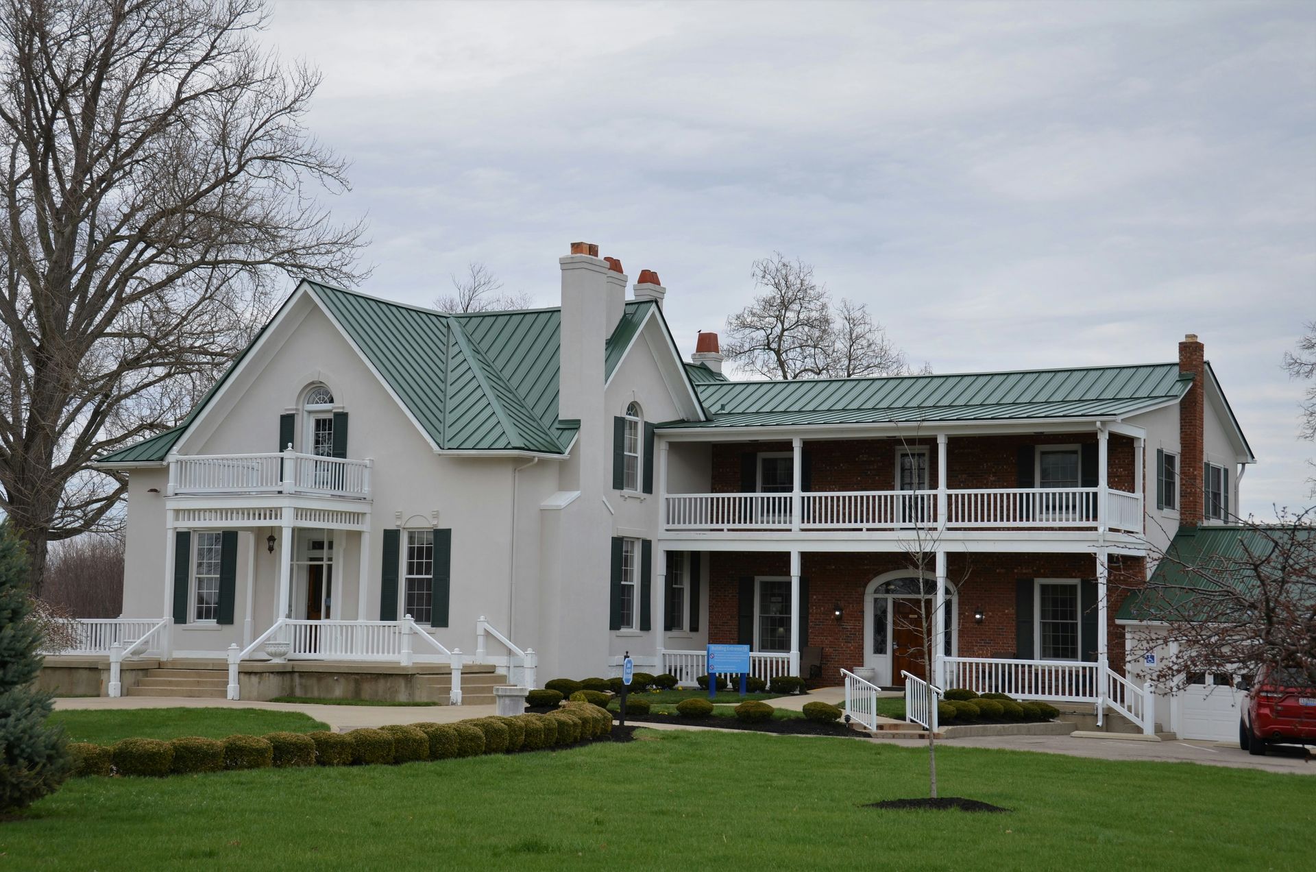 Woman at desk gestures toward man standing, in office setting.