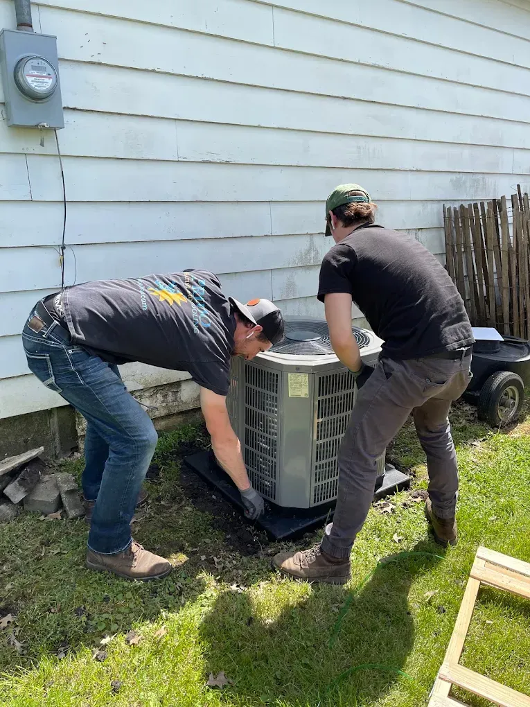 Woman at desk gestures toward man standing, in office setting.