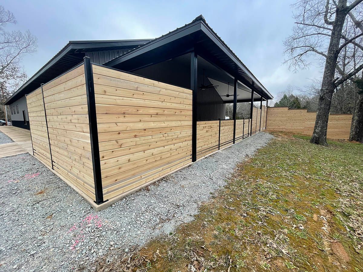 A house with a wooden fence in front of it.