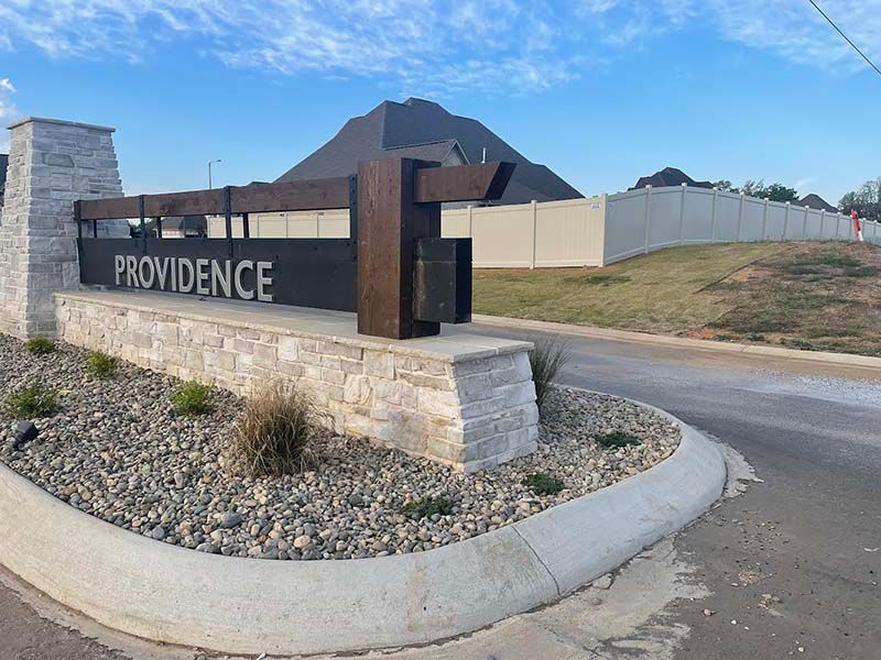 A stone wall with a sign that says providence on it