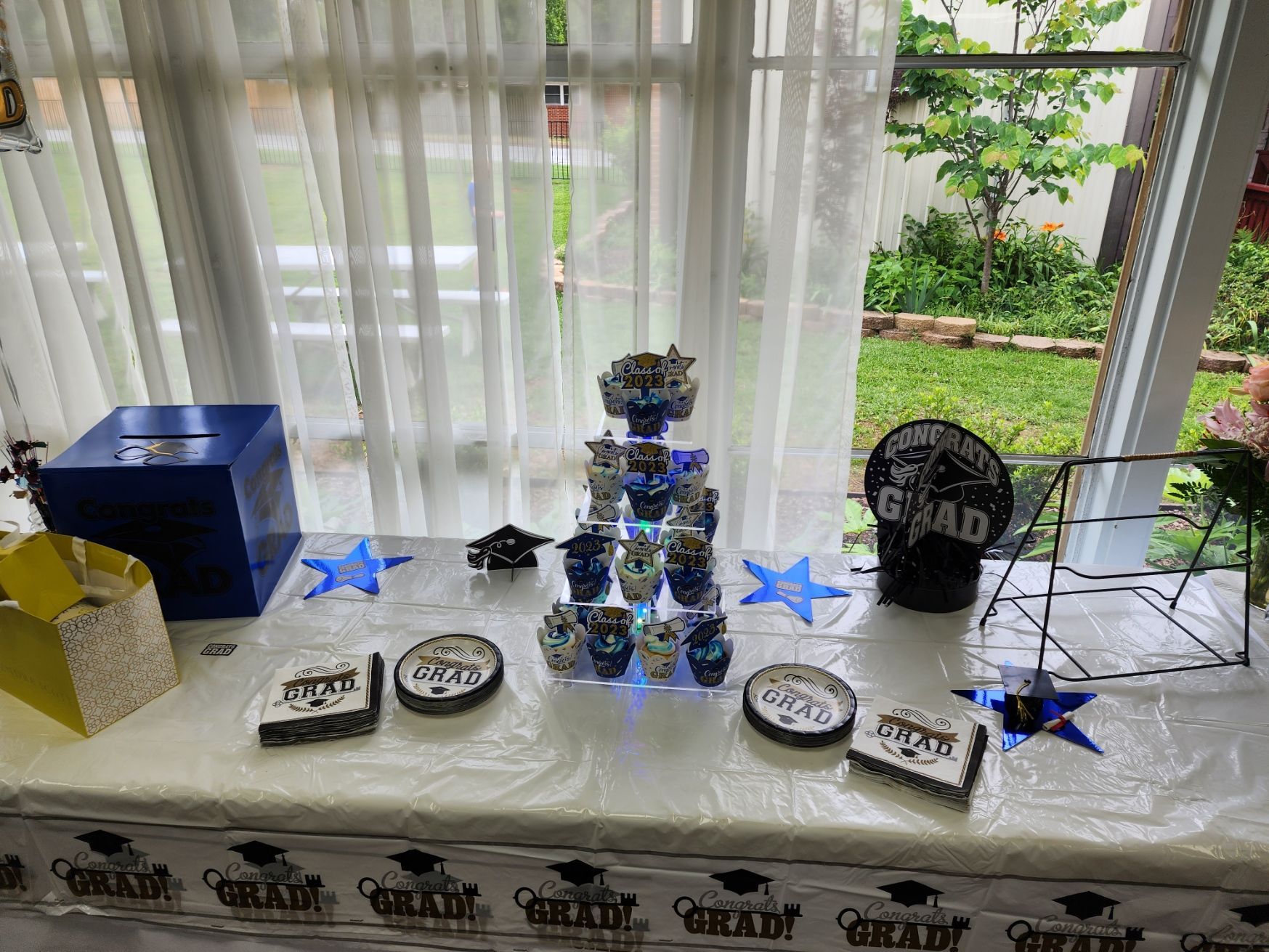 Graduation party table. Blue donation box, cupcakes, decorations, and a 