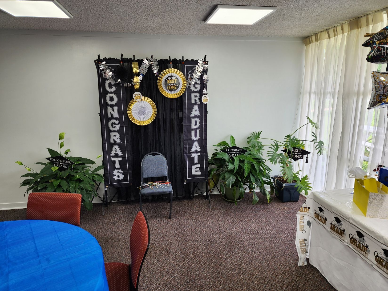 Graduation party scene. Black backdrop with 