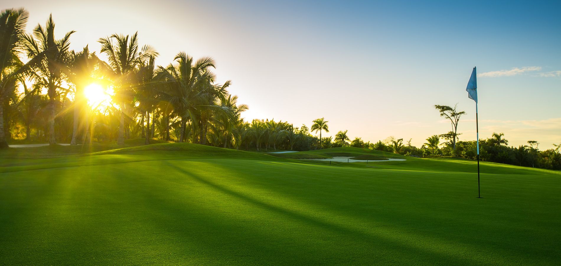 A dining room with a table and chairs and a wooden staircase.