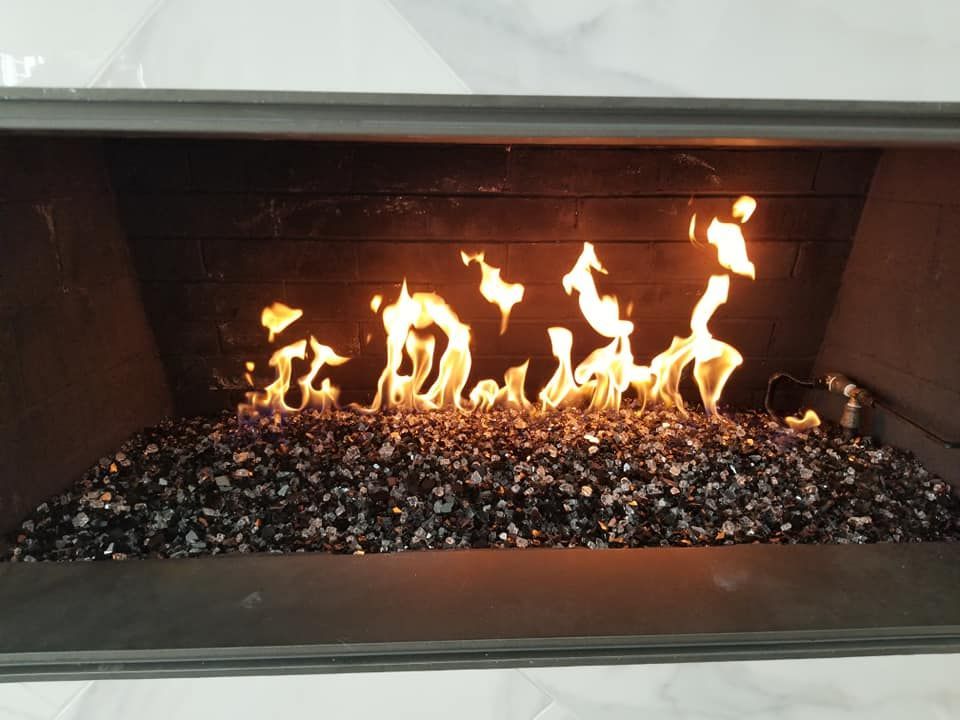 A man wearing a mask is carrying a cardboard box into a van.