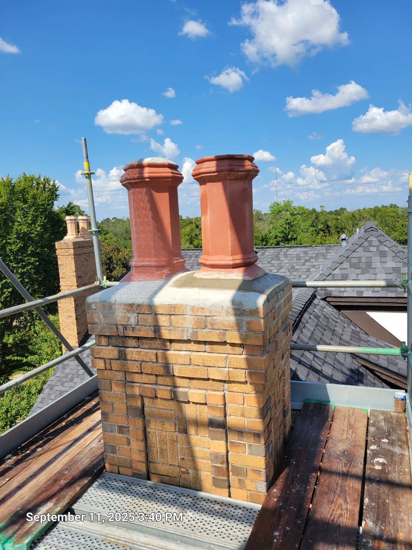 A delivery man in a red shirt is writing on a clipboard